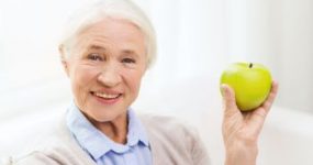 Eldery Woman with Osteoporosis Holding Apple Atlanta GA 