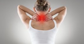 Woman Grabbing the Back of Her Neck in Pain Atlanta GA